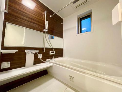 a bathroom with a bath tub and a sink at SALON Shibuya in Tokyo