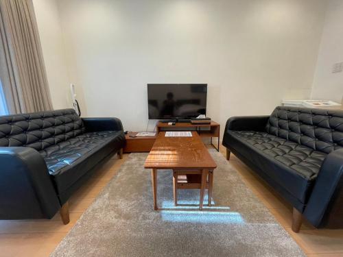 a living room with two couches and a coffee table at SALON Shibuya in Tokyo