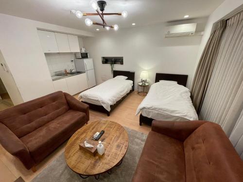 a living room with a couch and a table at SALON Shibuya in Tokyo