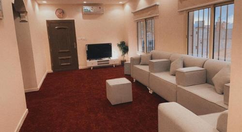 a living room with a couch and a flat screen tv at Flowers of Al hada in Al Hada