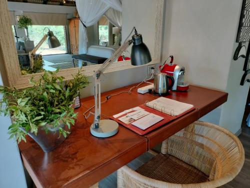 a desk with a lamp on top of it at Karongwe - River Safari Lodge in Hoedspruit