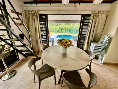 a dining room with a table and chairs and a pool at A Famosa resort villa 877 snooker karaoke BBQ 5BR in Kampong Alor Gajah