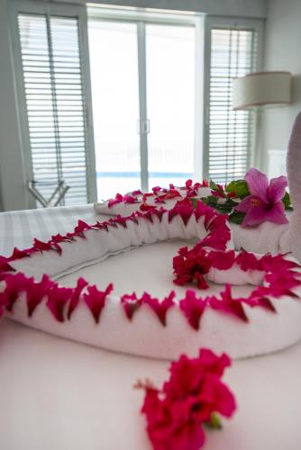 a cake with pink flowers on top of a table at Las Brisas Acapulco in Acapulco