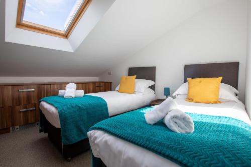 two beds sitting next to each other in a room at Dunston Stables- Spectacular Countryside Setting in Newton Abbot