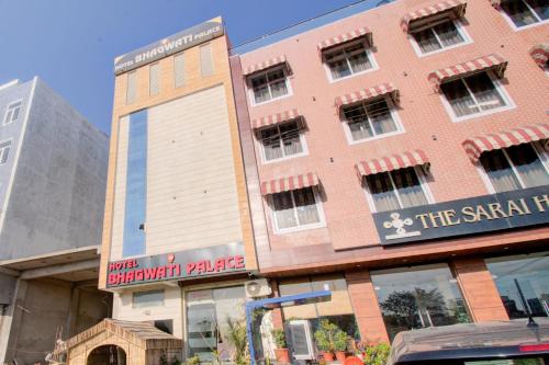 a building on the corner of a street at Hotel Bhagwati Palace in Jaipur