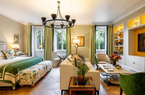 a bedroom with a bed and a living room at Rocco Forte Hotel De Russie in Rome