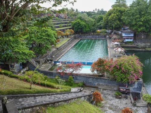 a large swimming pool in the middle of a river at RedDoorz @ Just in Mataram City in Mataram