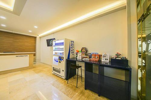a room with a counter and a refrigerator in it at Hotel Yeogiuhtte Donghae Mukho in Donghae