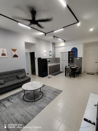 a living room with a couch and a ceiling fan at Ninety1 Sandakan in Sandakan