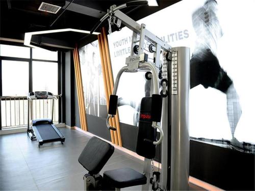 a room with a gym with a treadmill at Kyriad Hotel Changsha Environmental Protection Science and Technology Park in Yangtianhu