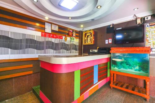 a colorful bar in a restaurant with a fish tank at OYO Gnana S.R.M Residency in Puducherry