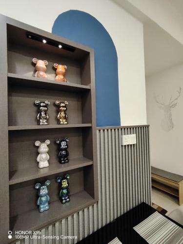 a shelf with stuffed animals in a room at Ninety1 Sandakan in Sandakan