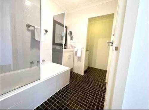 a bathroom with a tub and a shower and a sink at Sydney city meets village living in Sydney