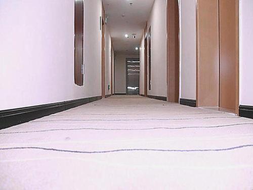 an empty hallway with white walls and an empty floor at City Comfort Inn Chenzhou Youa International Plaza in Chenzhou