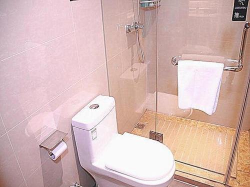 a small bathroom with a toilet and a shower at City Comfort Inn Chenzhou Youa International Plaza in Chenzhou