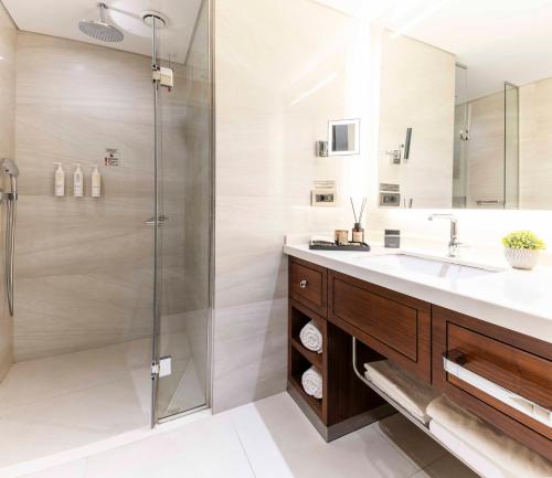 a bathroom with a sink and a shower at Tzl Suites Hotel Nişantaşı in Istanbul