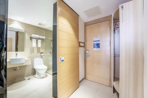 a bathroom with a toilet and a sink at City Comfort Inn Changsha Wanjiali Mawangdui Metro Station in Xingsha