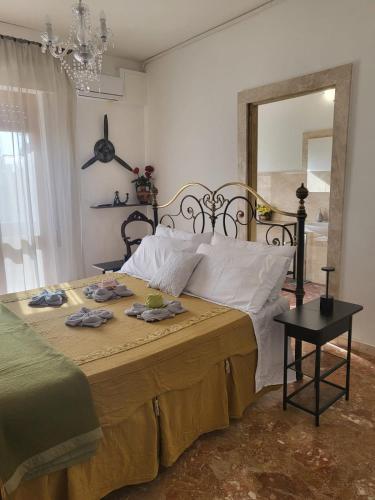 a bedroom with a large bed with a large mirror at La camera dell’aviatore in Alghero