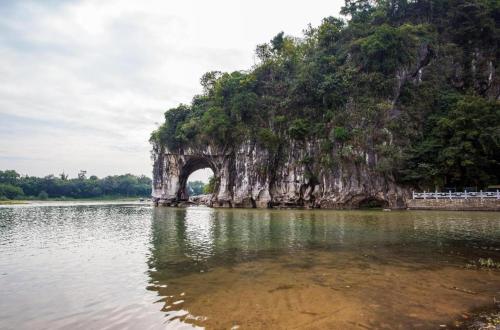 an island in the middle of a body of water at James Joyce Coffetel Guilin Railway Station Xiangbi Mountain Liangjiang Sihu Wharf in Guilin