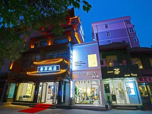 a group of buildings on a city street at night at Xana Hotelle Xi'an Zhonglou, Huimin Street Metro Station in Xi'an
