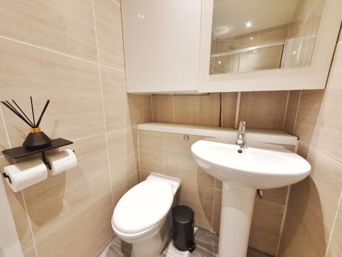 a small bathroom with a toilet and a sink at Hidden Leicester&Covent Garden Gem in London