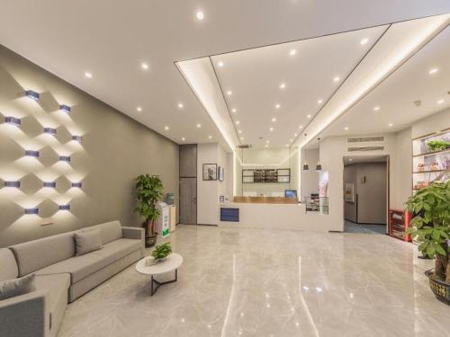 a lobby of a hospital with a couch and a table at 7 Days Premium Hotel Chongqing Jiefangbei No.1 Bridge Hongyadong in Chongqing