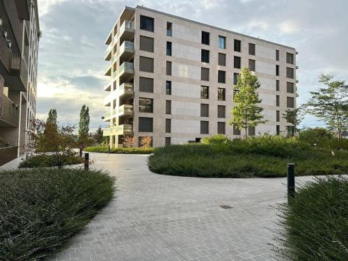 a large white building in front of a building at Beautiful High Standard Apartment in Luxembourg