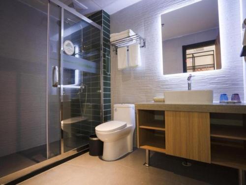 a bathroom with a toilet and a sink and a shower at GreenTree Inn Shangrao Wuyishan Avenue Meide Yinxiang in Shangrao
