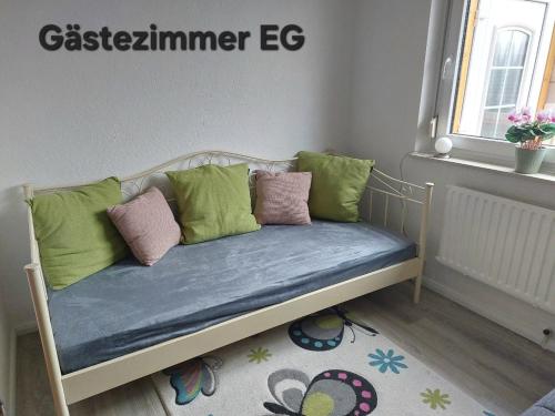 a bench with pillows on it in a room at Zum Eiderweg Hennstedt in Hennstedt