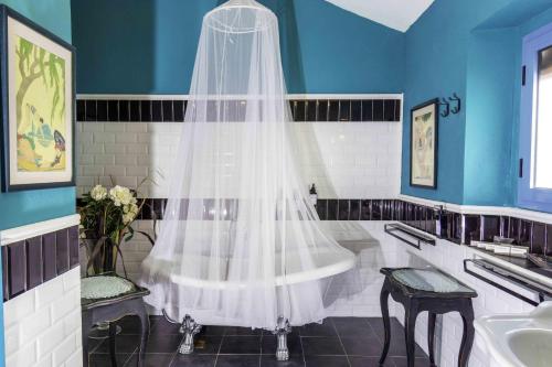 a white shower curtain in a bathroom with a sink at Hotel Utopía in Benalup Casas Viejas