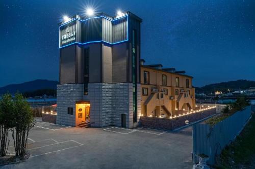 a building with lights on top of it at night at The Bay hotel & pool villa in Suncheon