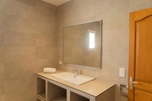 a bathroom with a sink and a mirror at Residence Mare e Sole in Taglio-Isolaccio