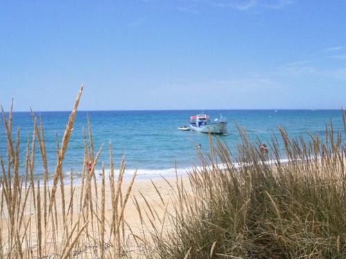 a boat in the water on the beach at Agri B&B Terre Joniche in Isola Capo Rizzuto