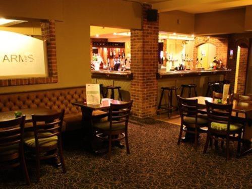 un restaurante con mesas y sillas y un bar en The Downe Arms en Snaith
