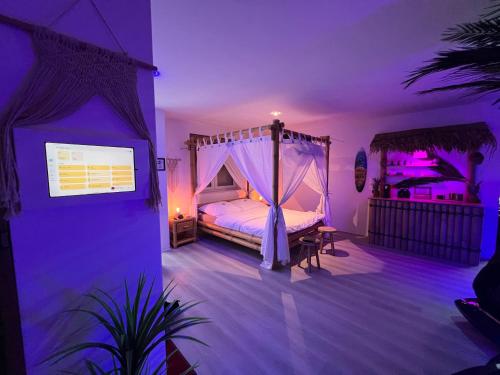 a bedroom with a canopy bed in a purple room at Relax-Suite in Gelsenkirchen