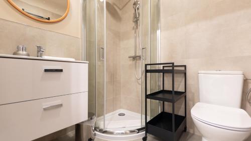 a bathroom with a shower and a toilet and a sink at VacationClub - Apartamenty Zakopiańskie Apartament 44 in Zakopane