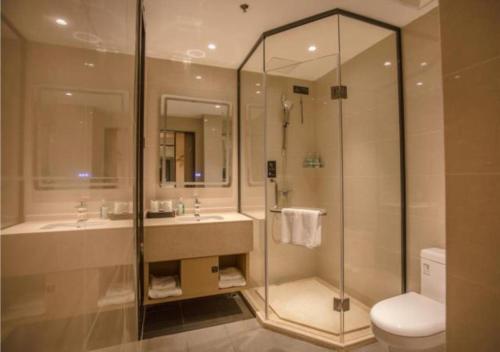 a bathroom with a shower and a sink and a toilet at City Comfort Inn Yangzhou Dongguan Street Heyuan in Yangzhou