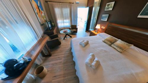 a bedroom with a large bed with two towels on it at Hotel Utopía in Benalup Casas Viejas