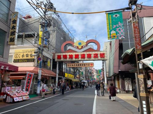 una calle en una ciudad asiática con gente caminando por la calle en winco, en Tokio