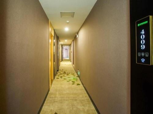 a long hallway with a sign on a wall at Green Tree Inn Express Yulin Chinese Medicine Port in Yulin