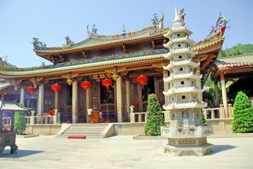 a building with a pagoda in front of it at VX Hotel Xiamen Siming District Xiamen University Huandao Road in Xiamen