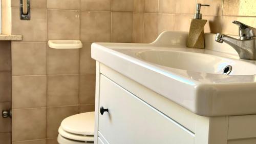 a bathroom with a white sink and a toilet at Trilocale centro Marcelli fronte mare - M223 in Marcelli