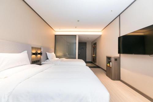 Uma cama ou camas num quarto em Hanting Hotel Jiaojiang Zhongshan West Road