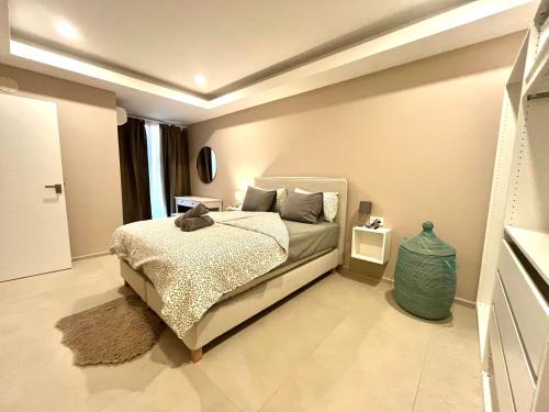 a bedroom with a bed and a vase in it at Kololi Sands Apartments in Sere Kunda