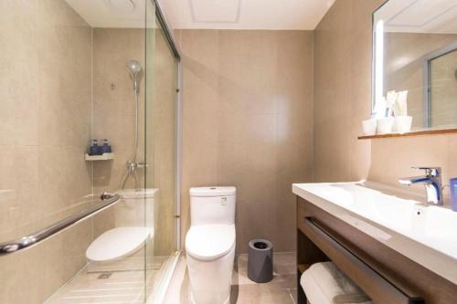 a bathroom with a shower and a toilet and a sink at Hanting Hotel Suqian Powerlong Plaza in Suqian