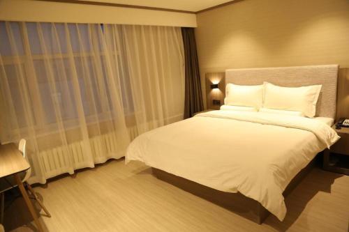 Ліжко або ліжка в номері Hanting Hotel Qiqihar Bukui Street Jiefang