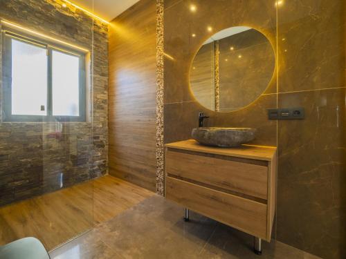 a bathroom with a sink and a mirror at Cubo's Casa Rural El Oasis De Don Pedro in Villafranco de Guadalhorce