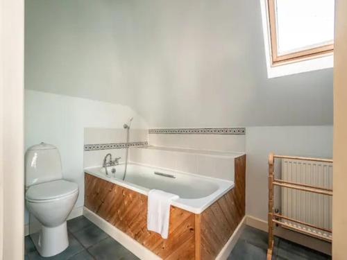 a bathroom with a toilet and a tub and a sink at Pass the Keys Clifftop home mature gardens stunning sea views in Teignmouth