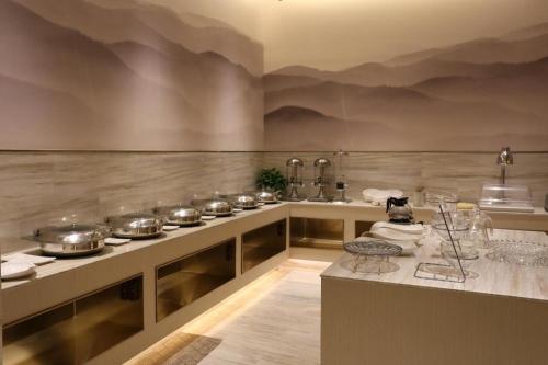 a kitchen with many pots and pans on a counter at Ji Hotel Yinchuan Guangyao Center in Yinchuan