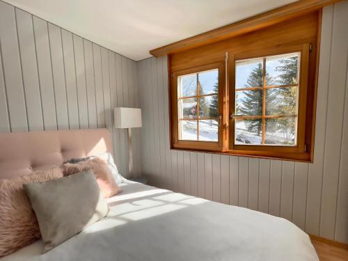 a bedroom with a bed and a window at Vieux Valais EG Ost in Bellwald